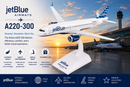 Model of a jetBlue Airways A220-300 airplane on a stand with sunset at an airport in the background.