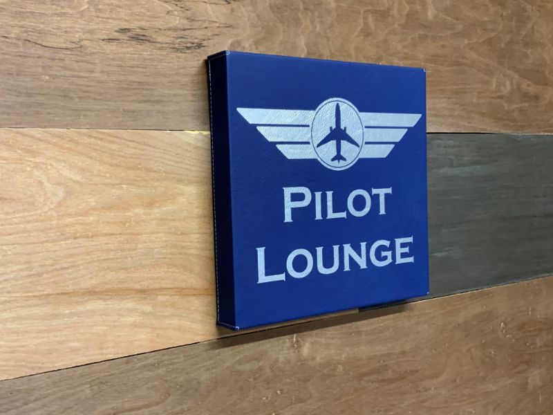 Pilot Lounge sign on wood wall