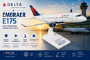 Model airplane on a stand with Delta branding against an airport backdrop