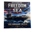 USS Abraham Lincoln aircraft carrier with text 'Defending Freedom from the Sea' and American flag in the background.