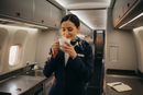 Flight attendant enjoying coffee