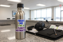 Trust Me I'm a Flight Instructor CFI sticker on a pilot water bottle at an FBO counter with headset and kneeboard
