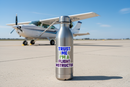 Trust Me I'm a Flight Instructor CFI sticker on a water bottle on the airport ramp with a Cessna 172 in the background