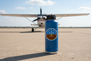 Student Pilot Attitude Indicator Stay Up Here sticker on a royal blue water bottle on the airport ramp with a Cessna 172 in the background