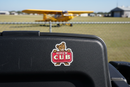Piper Cub sticker on kneeboard with yellow Piper Cub aircraft in background