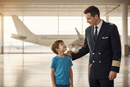 Young Boy Looking Up to Airline Pilot